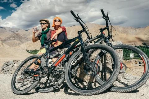 Two cyclists rest n the mountain road Stock Photos