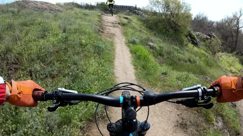 Two cyclists ride on a difficult rocky trail on mountain bikes. First-perso.. Stock Footage 274901330