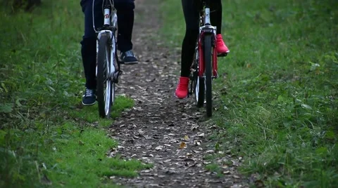 Two cyclists ride through the park. Close-up Stock Footage 56345735