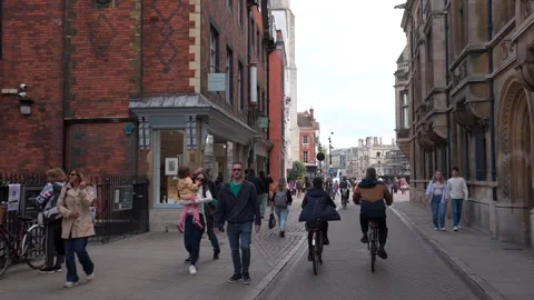 Two cyclists riding on a road through Cambridge, England 動画素材 278203599