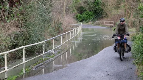 Two Cyclists at Smallbrook Road, Warminster, Wiltshire, UK Stock Footage 270160090