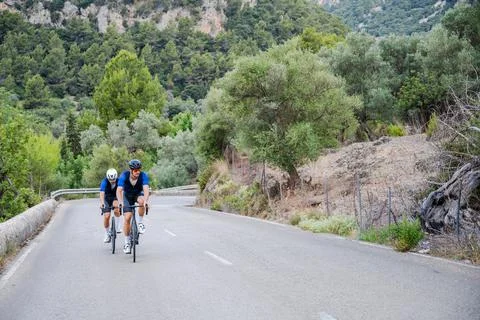 Two cyclists training on a mountain road Stock Photos
