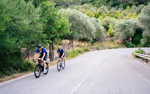 Two cyclists training on a mountain road. Cycling image with copy space. Healthy Stock Photos