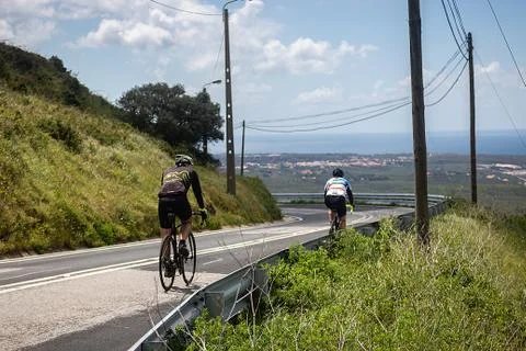 Two cyclists training on the roads of cascais, portugal Stock Photos