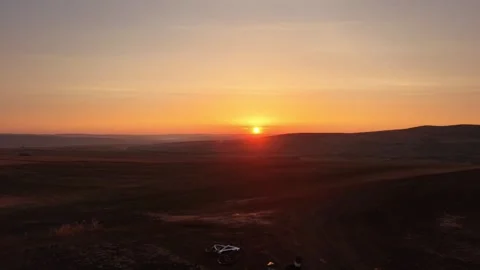 Two cyclists watching sunrise during peaceful morning ride Stock Footage 344358879