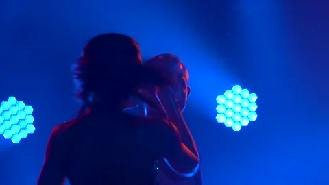 Two dancers enjoy a salsa dance in a dark studio with neon lights. Couple Stock Footage 140028178