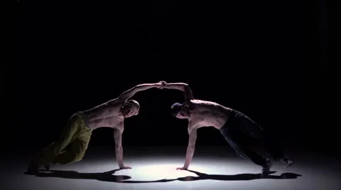 Two dancers performing and continue dance breakdance on black, shadow, slow Video stock 61178806