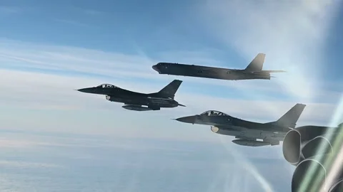 Two Danish Air Force F-16 Fighting Falcon's flying with USAF B-52 Stratofortress Stock Footage 292778045