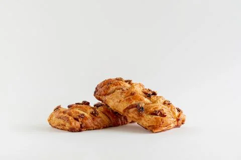 Two Danish maple pecan plaits pastry on a white background with copy space 写真素材
