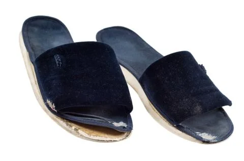 Two dark blue old worn out slippers seedy loking Stock Photos