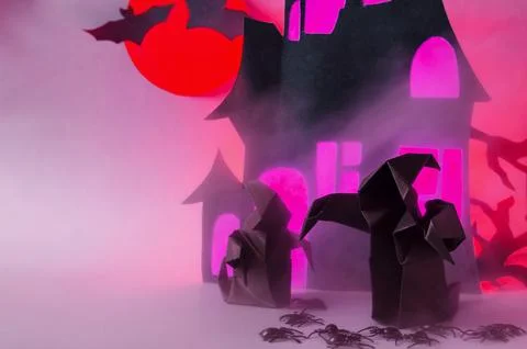 Two dark ghosts with a red glow in the fog against the background. Stock Photos