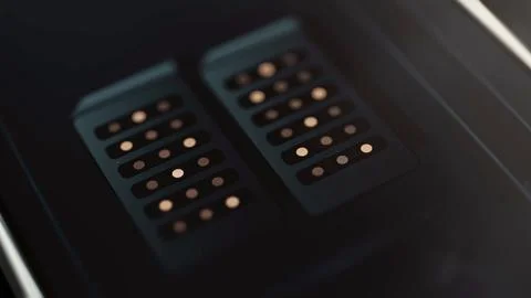 Two dark server cabinets display orderly rows of warm indicator lights 库存照片