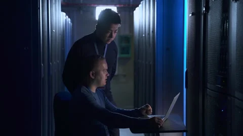 Two data engineers discussing IT project and using laptop at table in modern Stock Footage 166837569