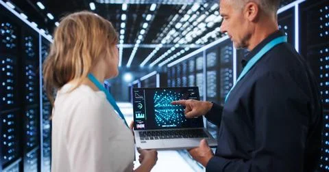 Two Data Scientists Discuss AI Model Training Inside The Busy Tech Center Roo Stock Photos