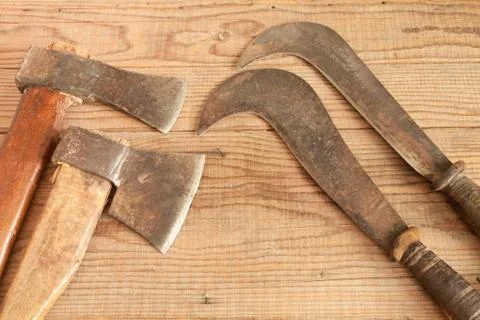 Two dated and used cleavers and billhooks on wooden background Foto stock