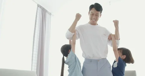 Two daughters hanging on your dad's arms Stock Footage 100945106