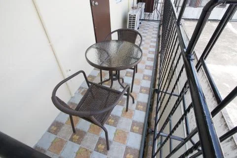 The two deck chairs and a small table in the balcony with a view Stock Photos