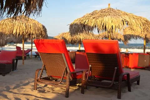 Two deck chairs on the beach Stock Photos