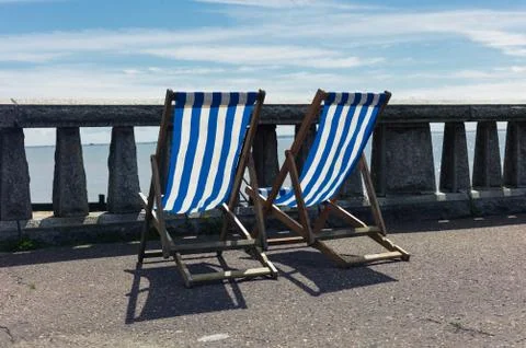 Two deck chairs by the seaside Stock Photos