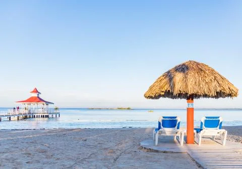 Two deck chairs under an umbrella Fotos Stock