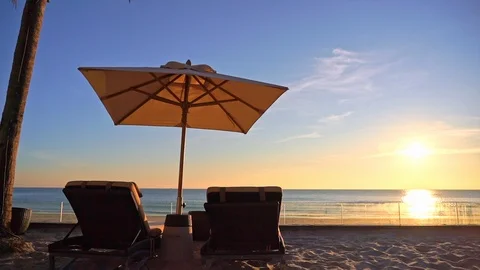 Two Deckchairs Under Parasol In Tropical Beach At Sunset Stock Footage 125438180