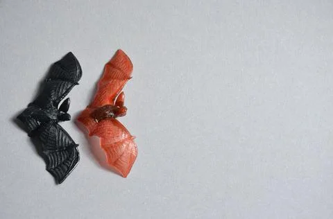Two decorative bats on a gray background. Halloween. Stock Photos