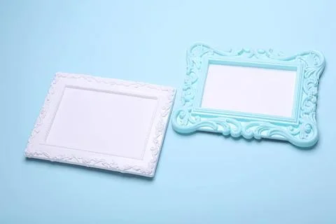 Two decorative empty picture frames on blue background Stock Photos
