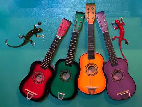 Two Decorative Lizards and Four Guitars Stock Photos