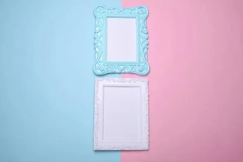 Two decorative picture frames on pastel blue and pink background Stock Photos