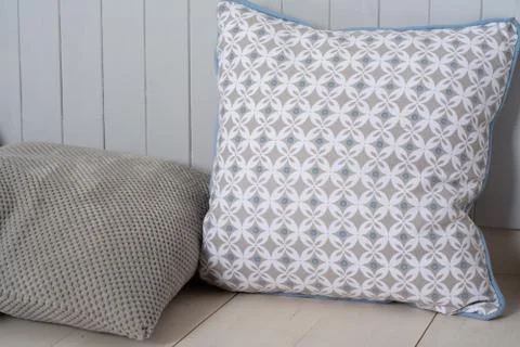 Two decorative pillows lie on the surface. Stock Photos