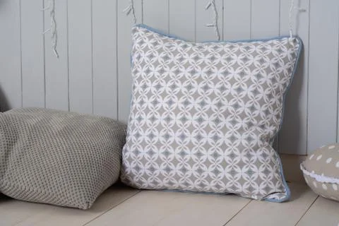 Two decorative pillows lie on the surface. Stock Photos