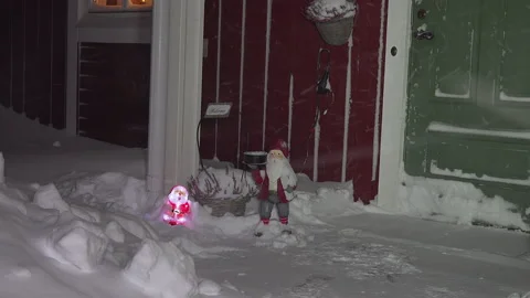 Two decorative snowmen - one plastic with light and another wooden Stock Footage 147410696