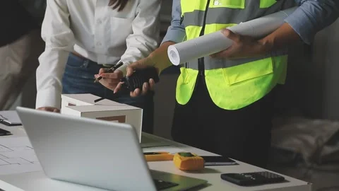 Two dedicated architects working on important project. Building in construc.. Stock Footage 309430421