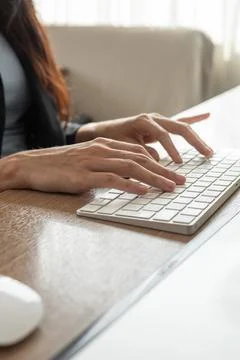 Two Delicate woman's hands working on a mouse a computer keyboard Stock Photos