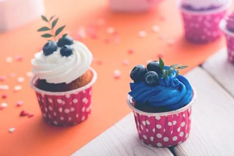 Two delicious cupcakes on a table Stock Photos