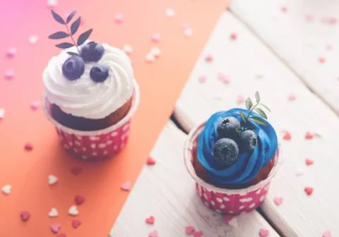 Two delicious cupcakes on a table Fotos de archivo