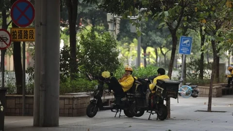 Two delivery guys having a smoking break from work in Guangzhou Stock Footage 243009103