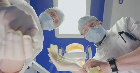Two dentists in white uniform preparing for tooth operation Personal or Patient Stock Footage 108541838