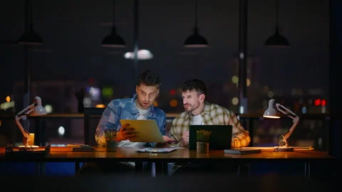 Two designers collaborating evening office. Creative night team planning project Stock Footage 339299944