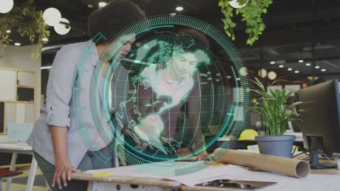Two designers leaning over plans, globe hovering over table, right peer Vídeo Stock 334694223