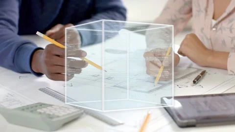 Two designers leaning over plans, pointing, marking, 3D cube appearing rotating Stock Footage 334703151