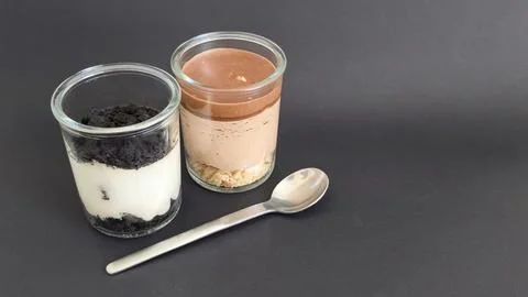 Two dessert jars and a horizontal spoon Stock Photos