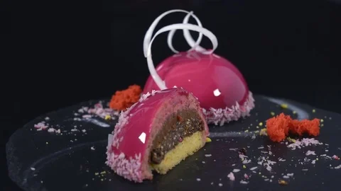 Two desserts under the icing rotate on a dark background Stock Footage 82081109