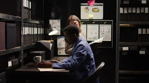 Two detectives cross-checking evidence Stock Footage 250682648