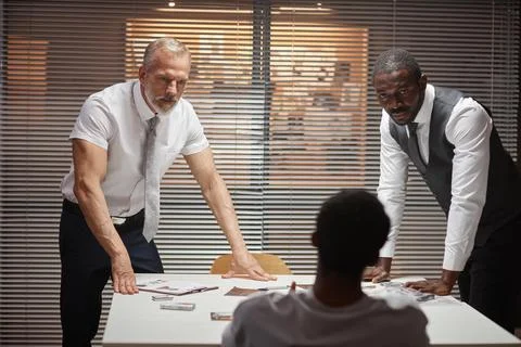 Two detectives interrogating suspect in criminal case Stockfoto's
