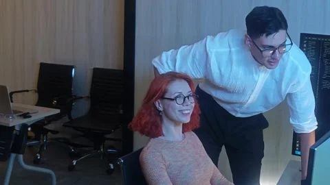 Two developer colleagues collaborating on programming and data analysis usi.. 動画素材 316042041