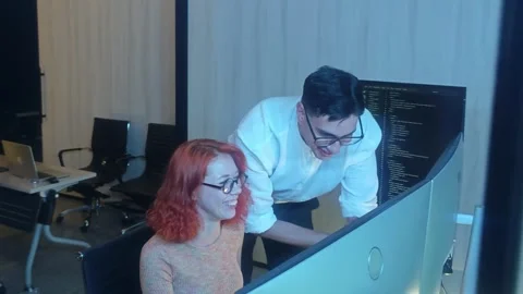 Two developer colleagues collaborating on programming and data analysis usi.. Stock Footage 316042056