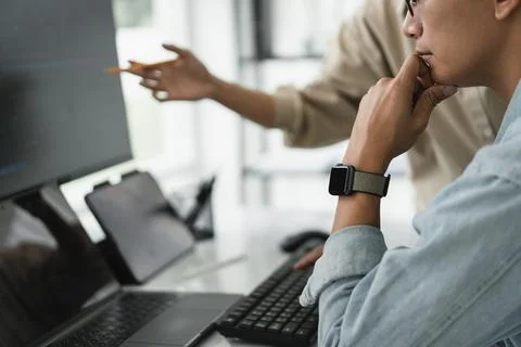 Two developer programmer discussing to checking code on monitor about progr.. 스톡 사진