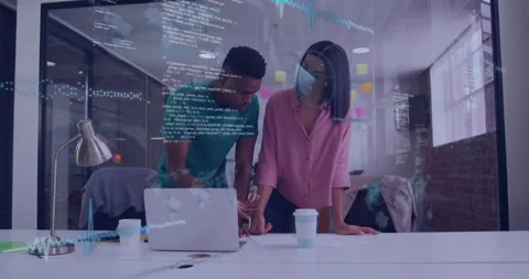 Two developers collaborating at table in tech office with sticky notes and code Stock Footage 307432400