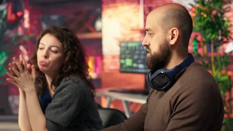 Two developers team interact with virtual AI assistant on PC Stock Footage 308604050